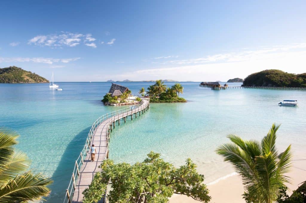 a panoramic view the boardwalk to an overwater bungalow at Fiji's Likuliku Lagoon Resort