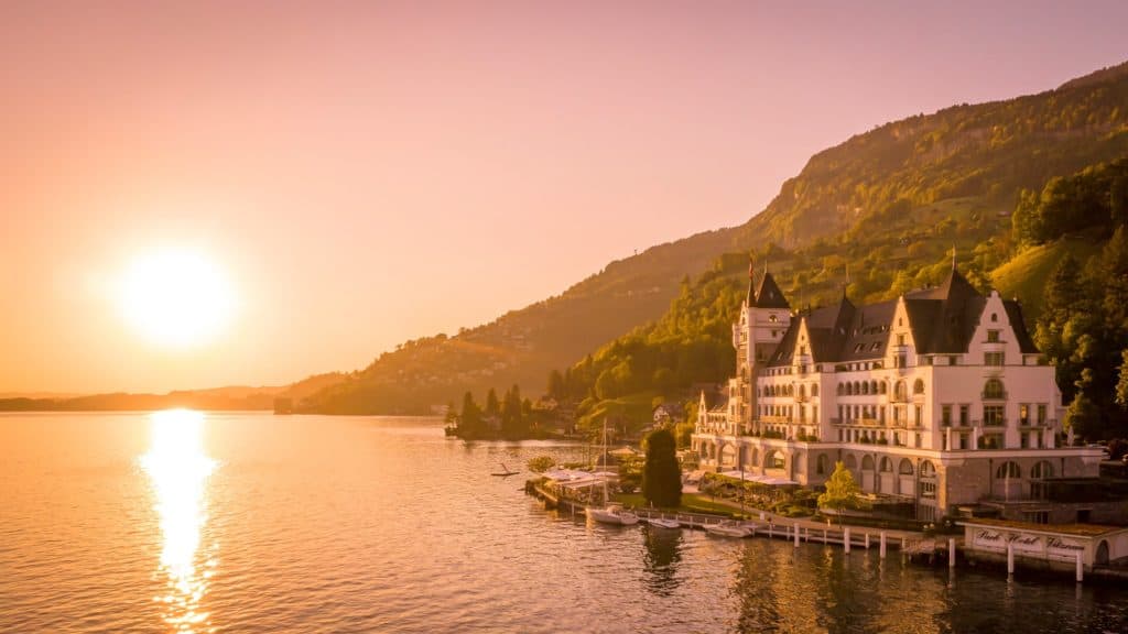 an exterior view of Lake Lucerne and the park hotel vitznau in Switzerland.