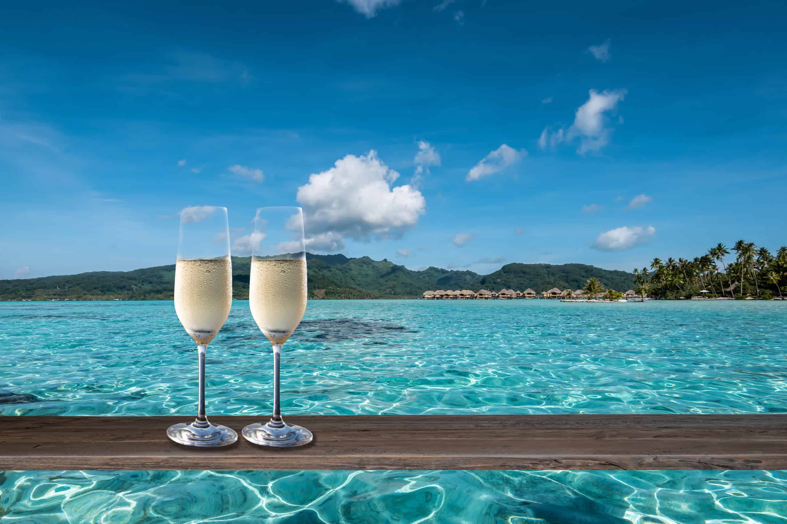 Luxury bora bora honeymoon celebration with two glasses of champagne in french polynesia